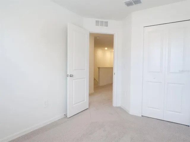 a view of kitchen with refrigerator and white wall