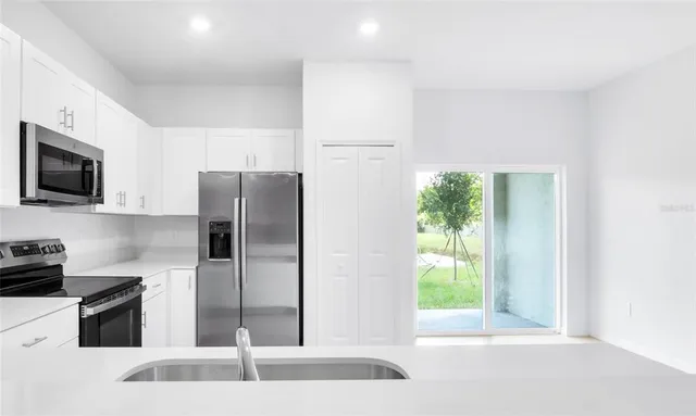 a white toilet sitting next to a white cabinet