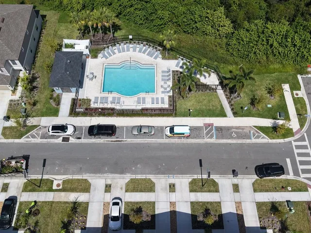 a view of a house with pool and chairs