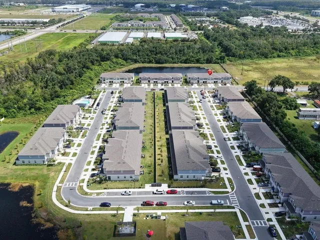 a aerial view of a house with swimming pool and mountains