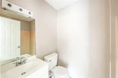 a bathroom with a sink a toilet and mirror