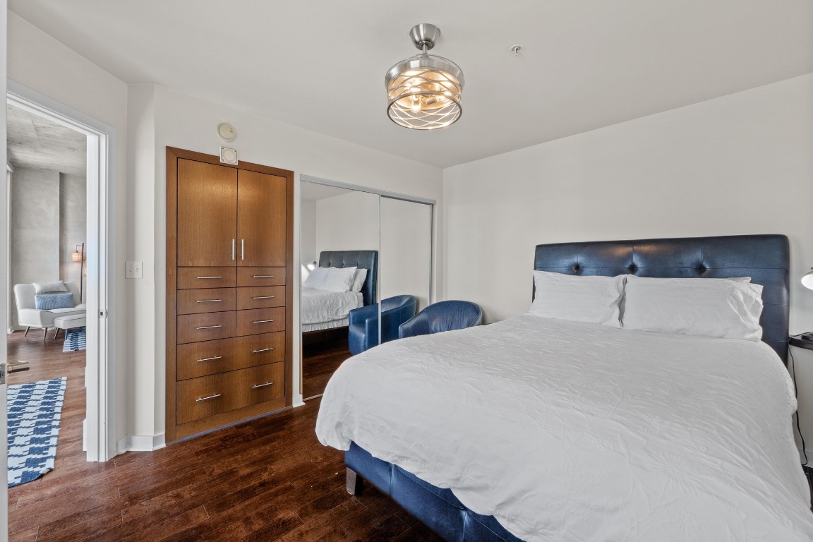 360 Nueces Street, Unit 2808 Austin, TX 78701 - Photo 12 of 29 a bedroom with a bed and a chandelier