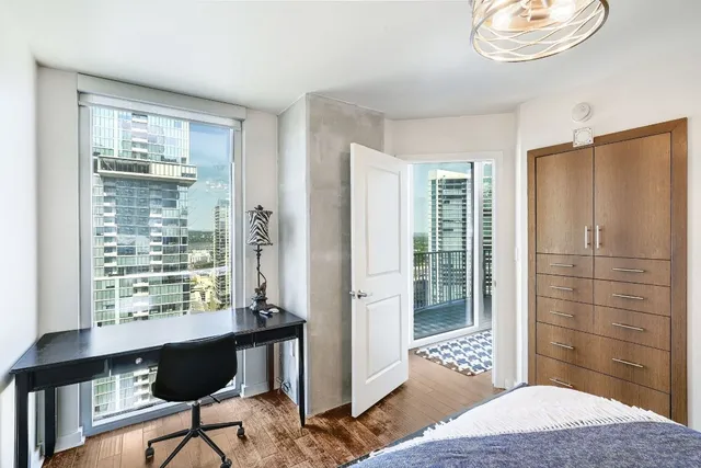 a bedroom with a bed and a window