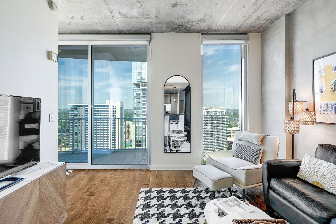 360 Nueces Street, Unit 2808 Austin, TX 78701 - Photo 2 of 29 a living room with furniture and a flat screen tv