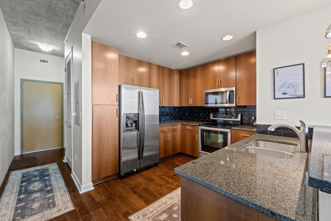 360 Nueces Street, Unit 2808 Austin, TX 78701 - Photo 9 of 29 a kitchen with granite countertop a refrigerator and a sink