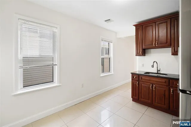 a kitchen with stainless steel appliances granite countertop a stove sink and cabinets