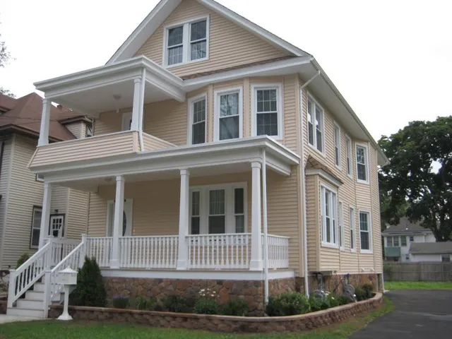 a view of a wooden house with a small yard