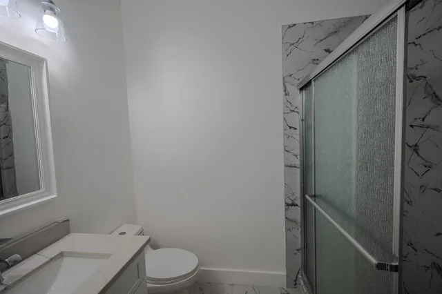 a bathroom with a toilet and a shower