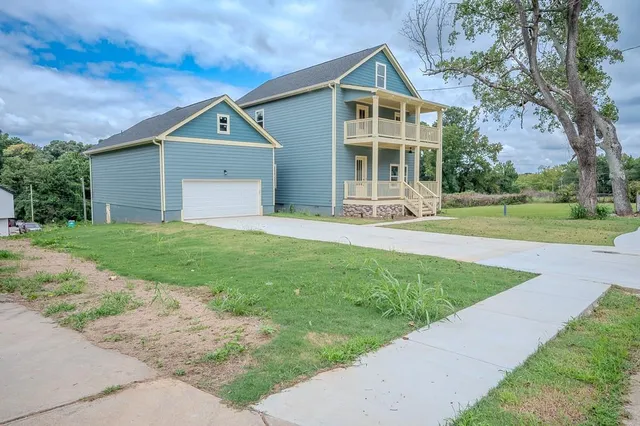 a front view of a house with a yard and porch