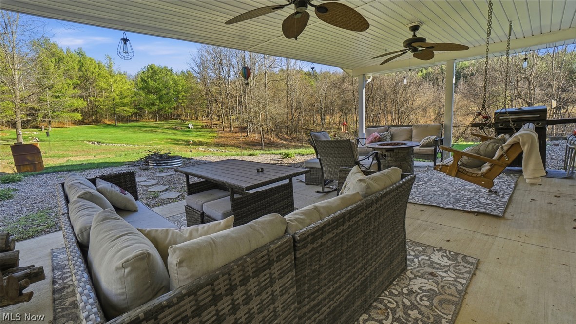 65892 Endley Road Cambridge, OH 43725 - Photo 45 of 50 View of patio with an outdoor living space with a fire pit and ceiling fan