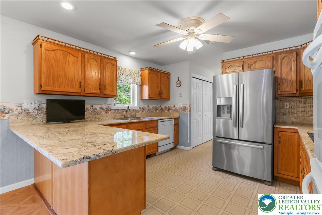 540 Bauer Road Bath, PA 18014 - Photo 16 of 50 a kitchen with stainless steel appliances granite countertop a refrigerator a sink dishwasher with a stove and refrigerator