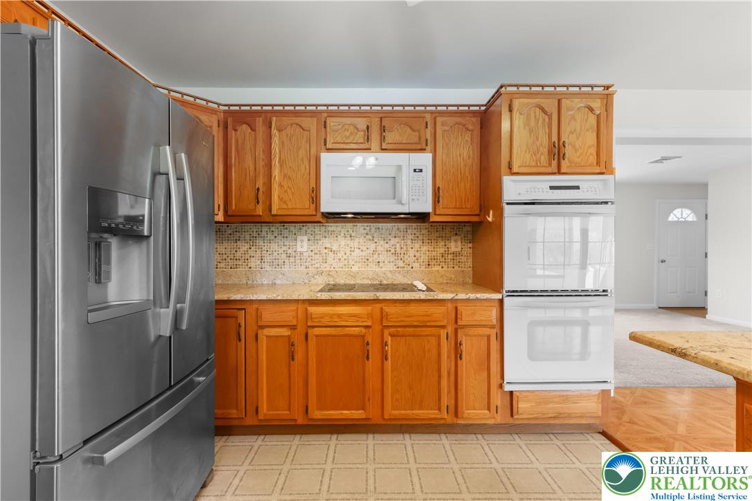 540 Bauer Road Bath, PA 18014 - Photo 17 of 50 a kitchen with stainless steel appliances granite countertop a refrigerator and a stove