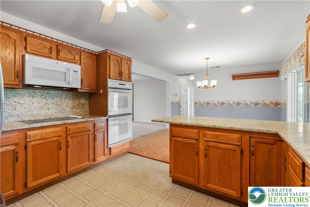 540 Bauer Road Bath, PA 18014 - Photo 18 of 50 a large kitchen with stainless steel appliances granite countertop a sink and cabinets