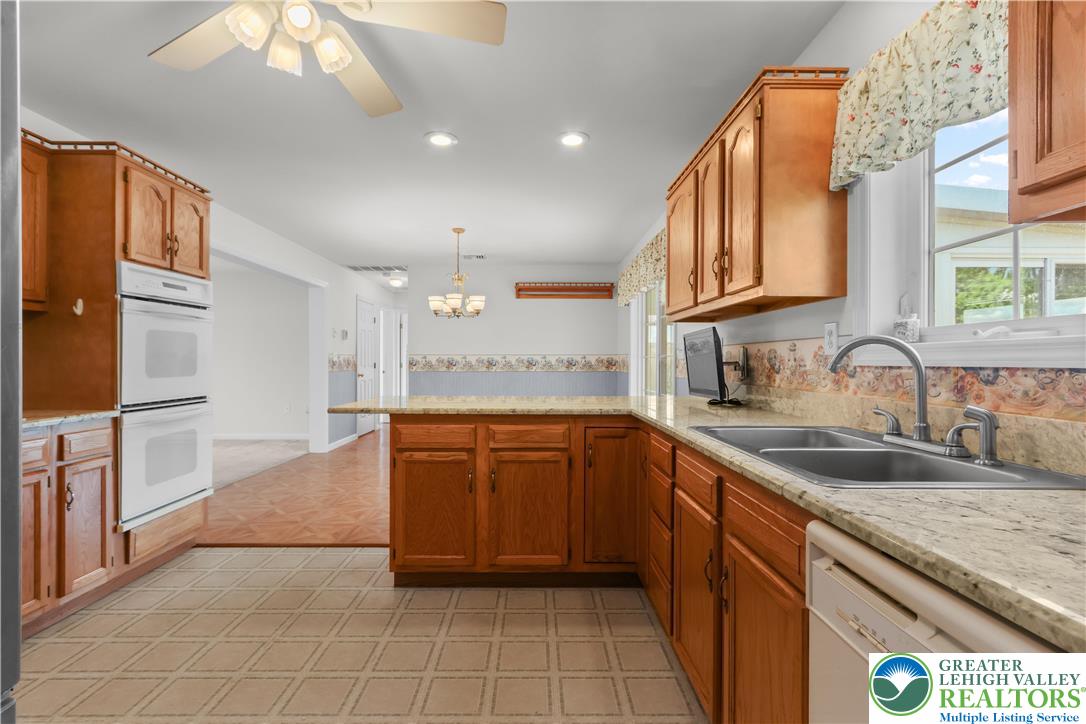 540 Bauer Road Bath, PA 18014 - Photo 19 of 50 a large kitchen with stainless steel appliances granite countertop a sink and dishwasher a stove with wooden cabinets