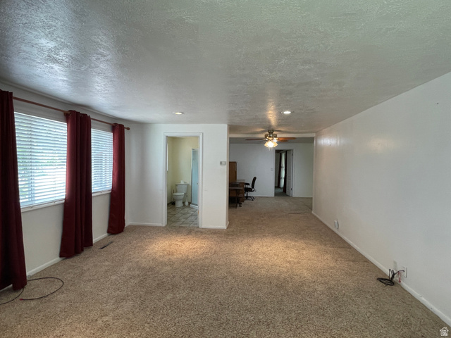 438 East Main Street Elsinore, UT 84724 - Photo 29 of 43 Spacious second sleeping area in Primary Suite featuring carpet flooring, multiple windows with blinds, a recessed ceiling light, and access to a bathroom with tile flooring