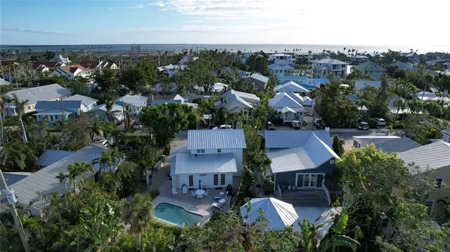 an aerial view of multiple houses with a yard