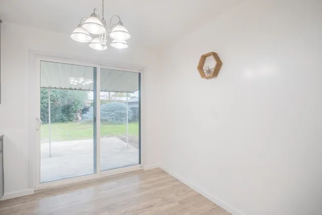 a view of a room with wooden floor and windows