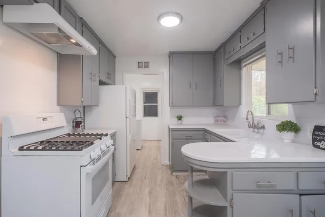a kitchen with a sink stove and refrigerator