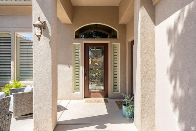 1609 East 10 S Street St. George, UT 84790 - Photo 7 of 68 Arched entry with a wood-finish door, decorative glass inserts, and flanking sidelights