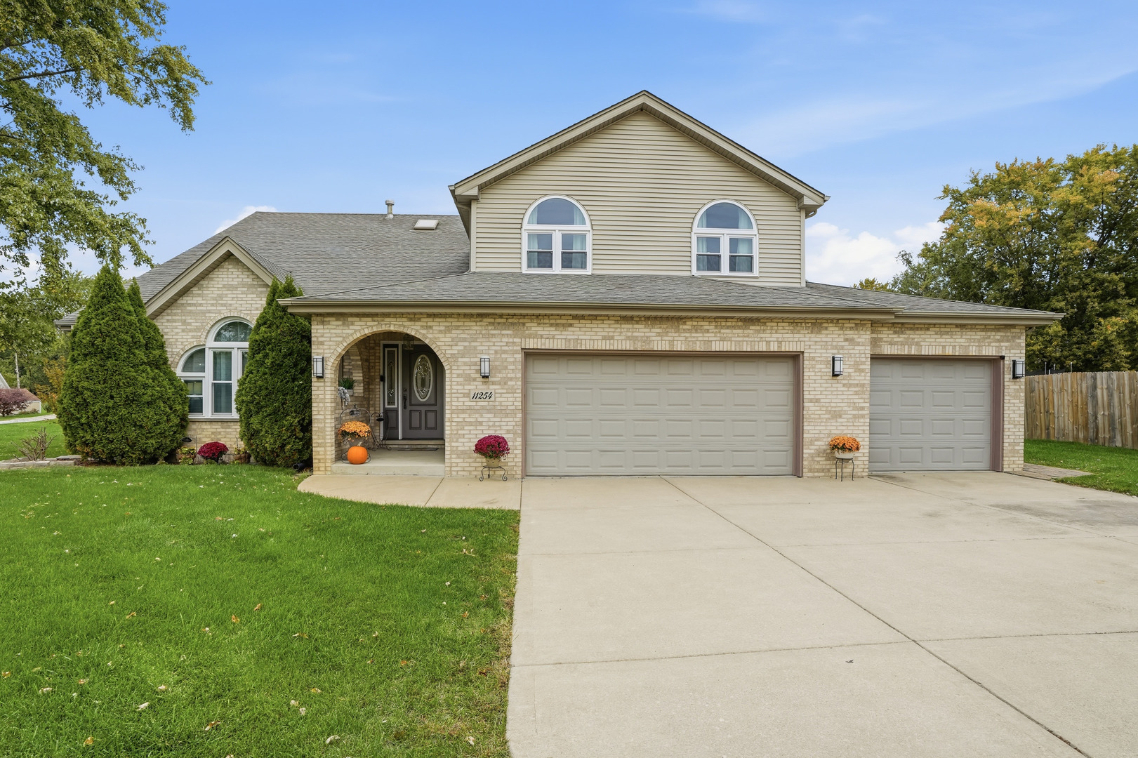 a front view of a house with yard and garage