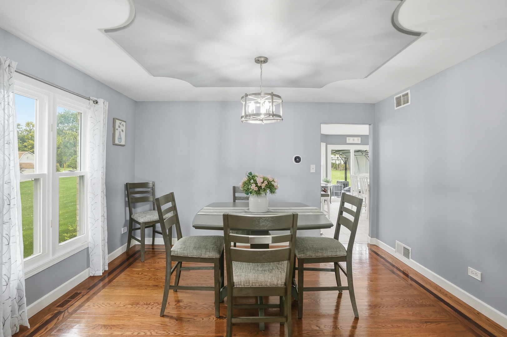 11254 192nd Street Mokena, IL 60448 - Photo 19 of 48 a dining room with furniture a window and wooden floor