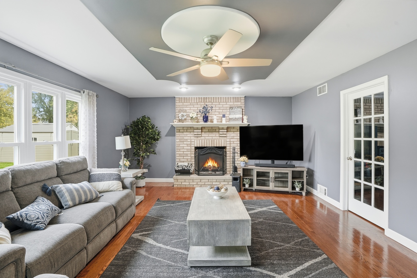 11254 192nd Street Mokena, IL 60448 - Photo 5 of 48 a living room with furniture a flat screen tv and a fireplace