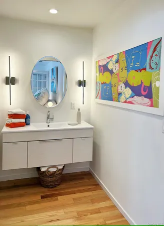 a bathroom with a sink mirror and vanity