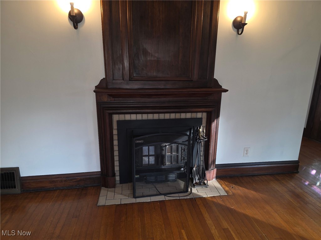 64 Sheldon Street Rittman, OH 44270 - Photo 23 of 37 Detailed view of wood finished floors and a wood stove