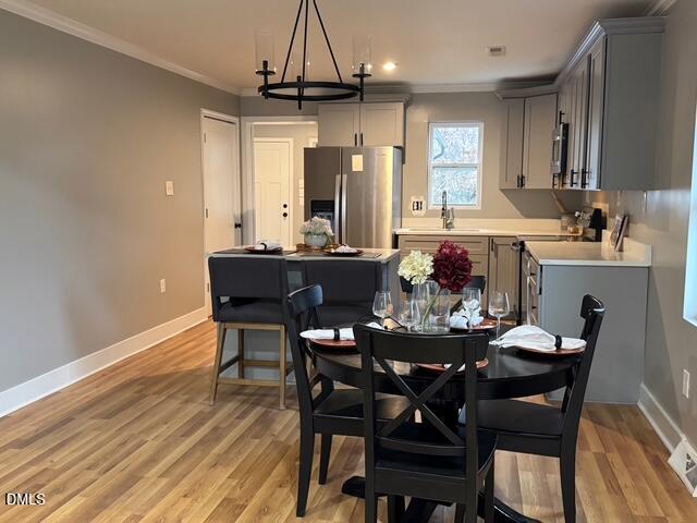 1005 East Hanover Road Graham, NC 27253 - Photo 5 of 8 a view of a dining room with furniture window and wooden floor