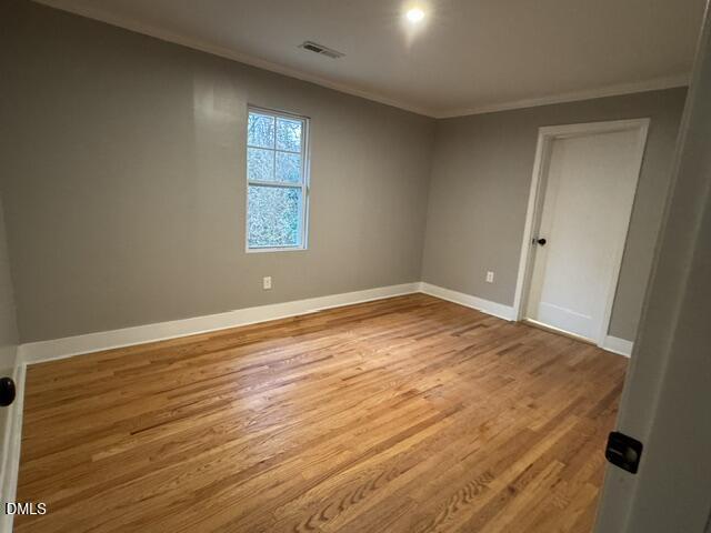 1005 East Hanover Road Graham, NC 27253 - Photo 7 of 8 an empty room with wooden floor and windows