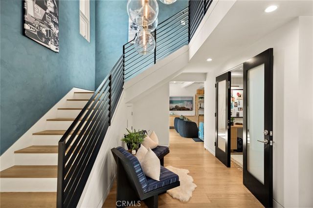 a view of entryway and hall with wooden floor