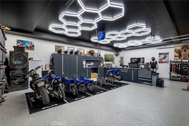 an aerial view of a house with a lake