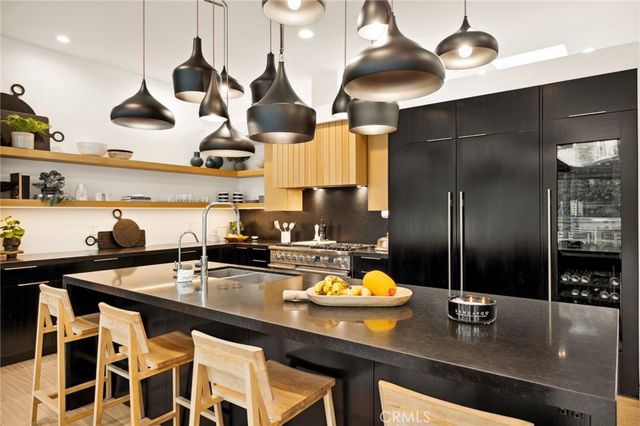 a kitchen with a sink a counter space and stainless steel appliances