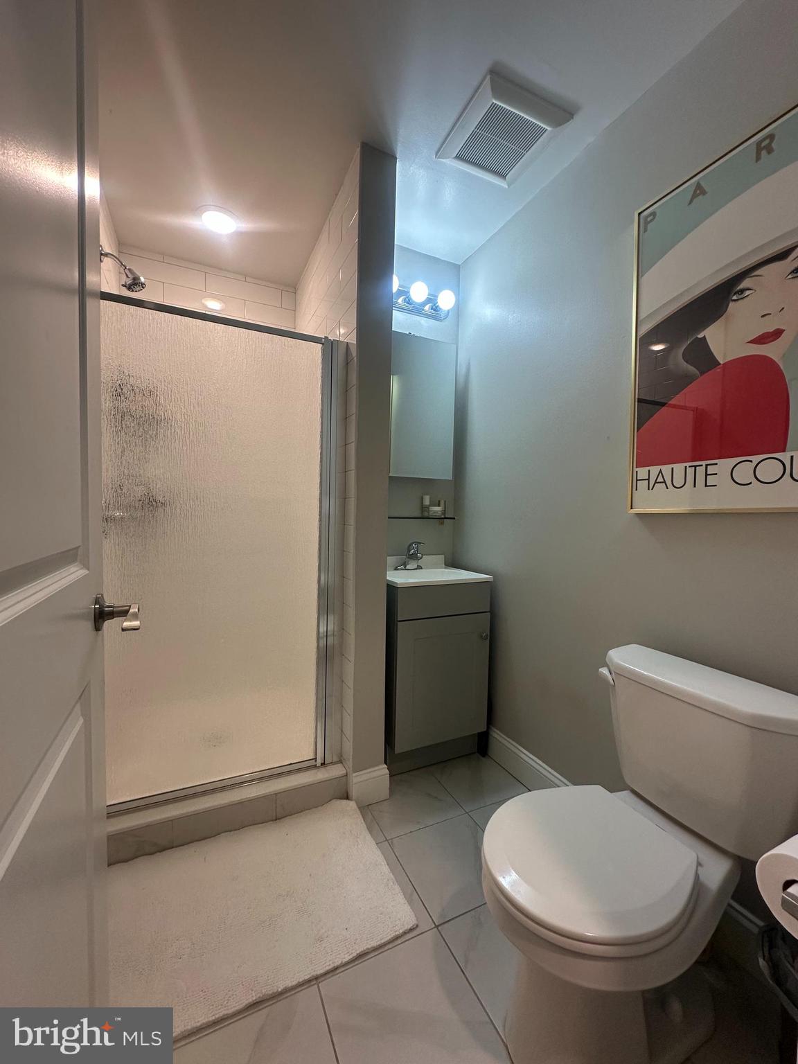 1015 Clinton Street, Unit 1F Philadelphia, PA 19107 - Photo 16 of 17 a white toilet sitting next to a bathroom sink