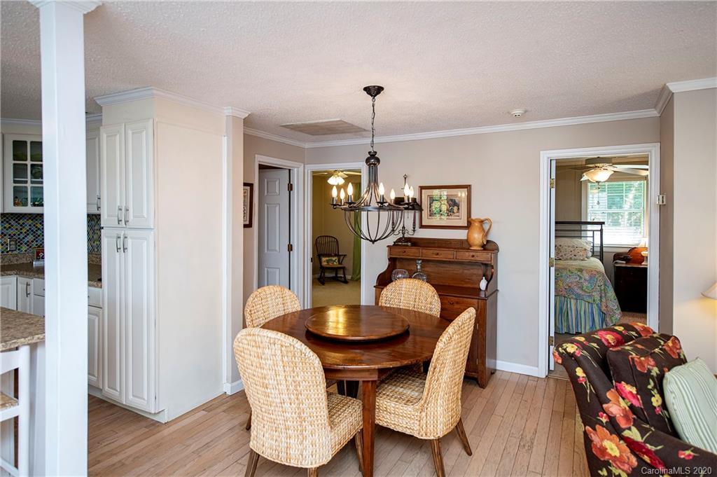 817 Bonum Road Lake Wylie, SC 29710 - Photo 20 of 41 a dining room with furniture a chandelier and wooden floor