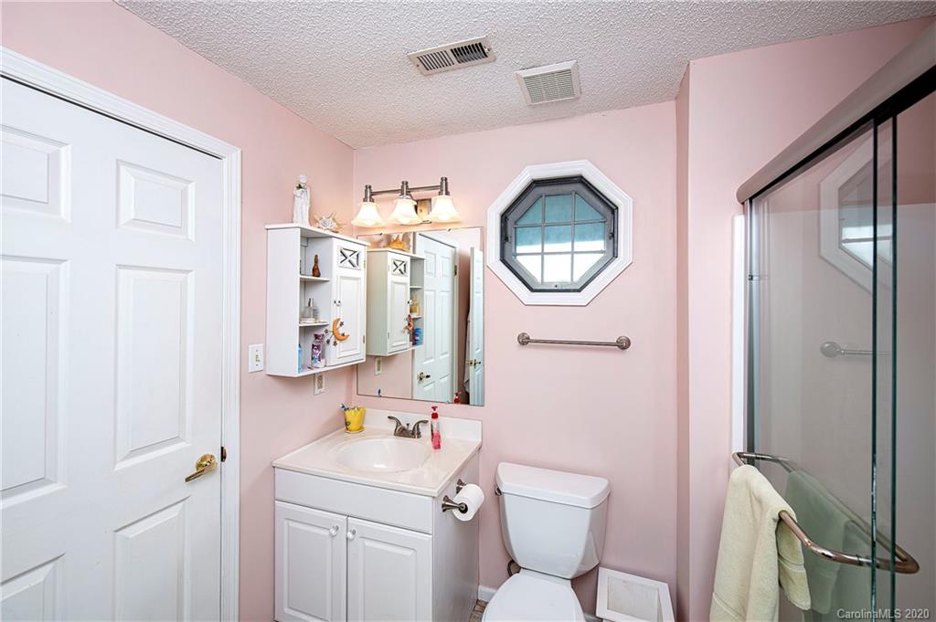 817 Bonum Road Lake Wylie, SC 29710 - Photo 23 of 41 a bathroom with a toilet sink vanity tub and mirror