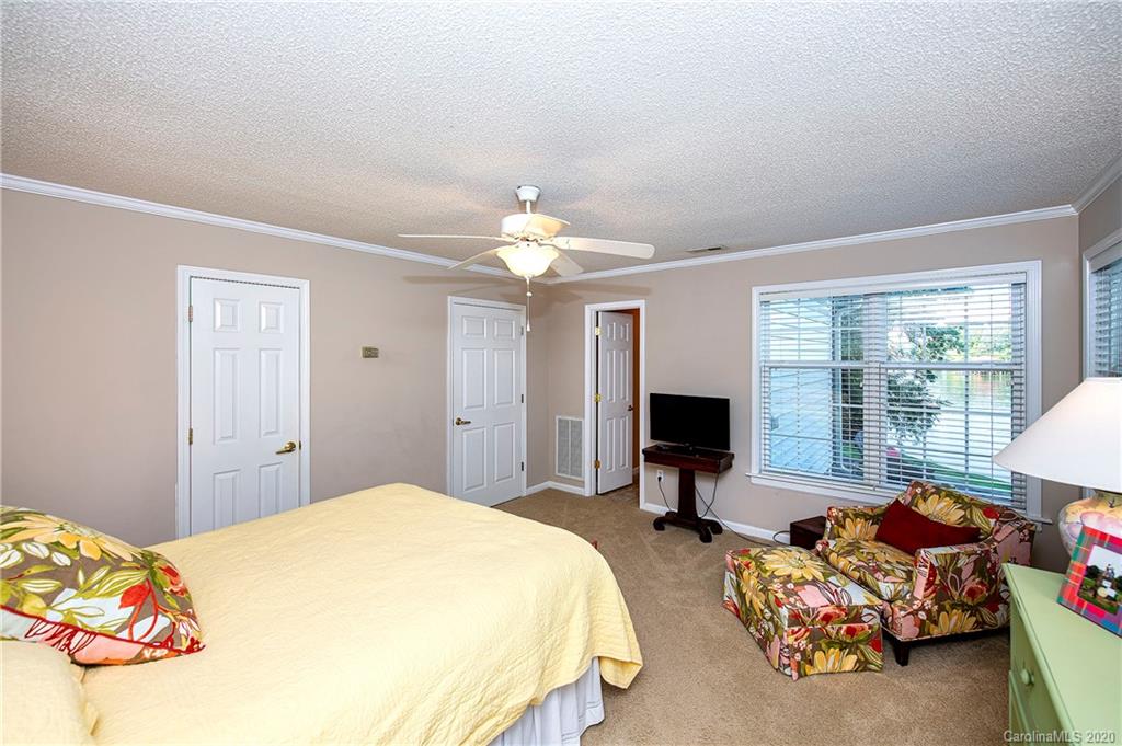 817 Bonum Road Lake Wylie, SC 29710 - Photo 25 of 41 a spacious bedroom with two bed and a chandelier
