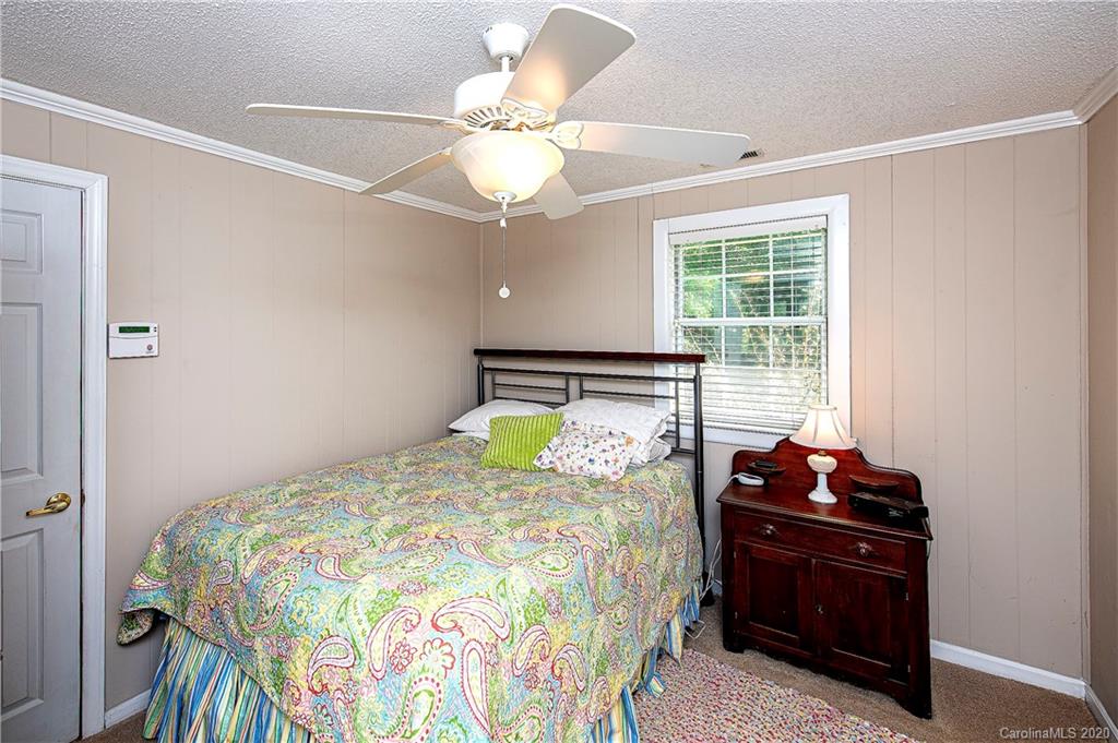 817 Bonum Road Lake Wylie, SC 29710 - Photo 29 of 41 a bedroom with a bed and a chandelier