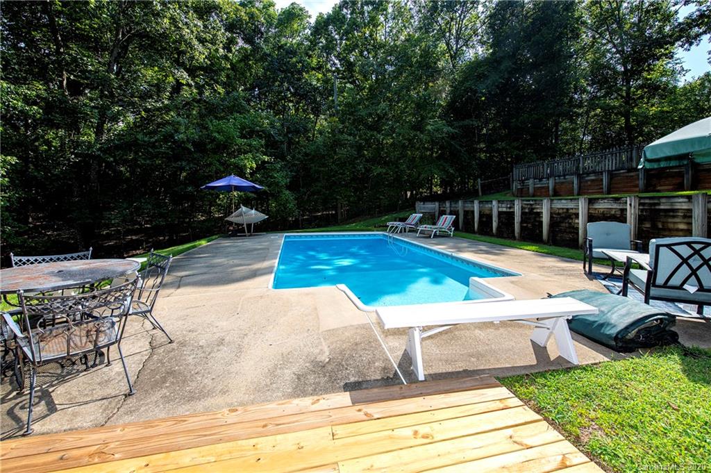 817 Bonum Road Lake Wylie, SC 29710 - Photo 39 of 41 a view of a swimming pool with lawn chairs under an umbrella