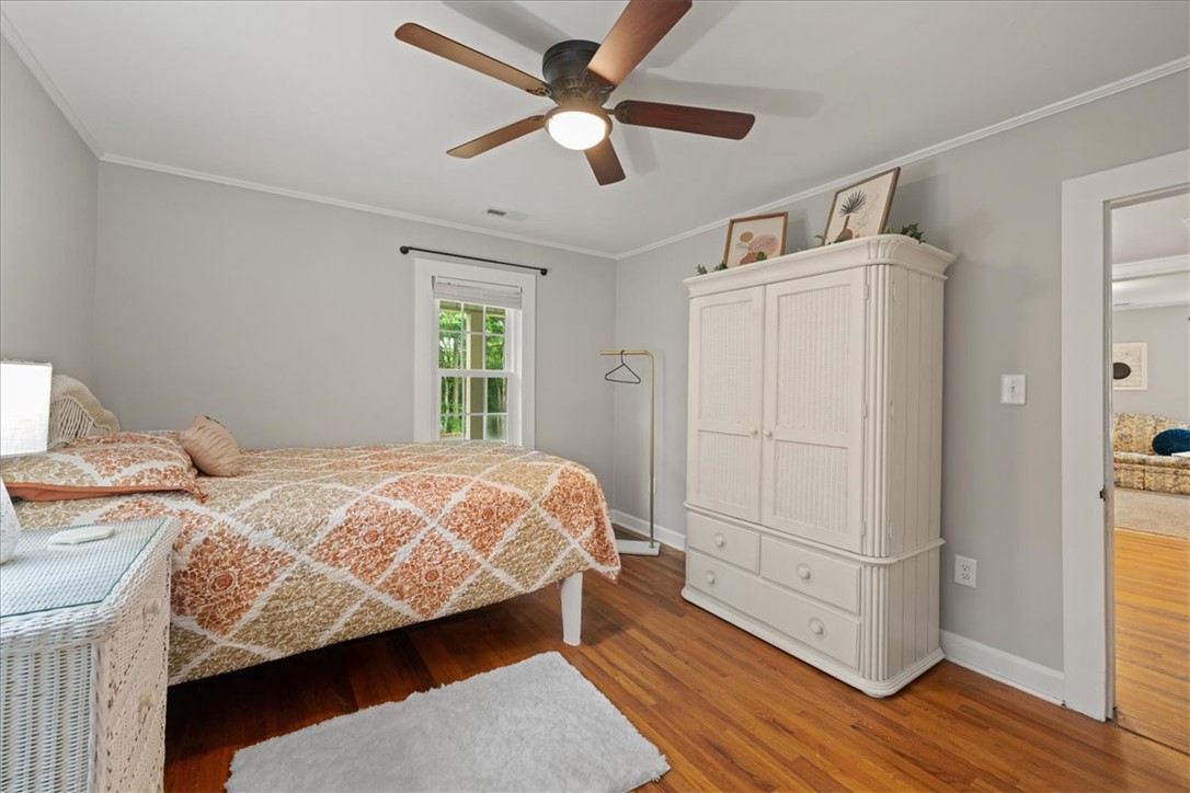 174 Holliday Road Six Mile, SC 29682 - Photo 27 of 49 Hardwood floors and crown molding elevate this charming Primary bedroom's comfort