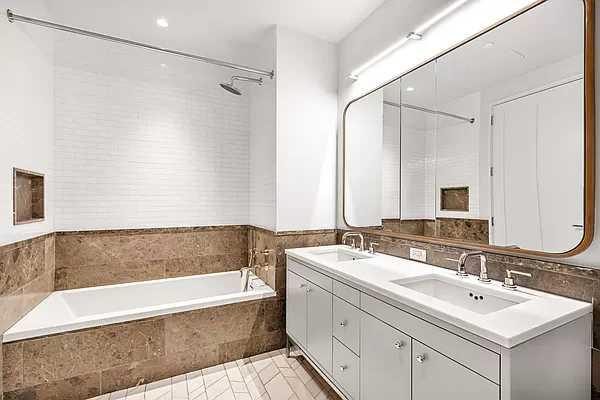 1 Clinton Street, Unit 17B Brooklyn, NY 11201 - Photo 1 of 4 a bathroom with a tub sink and mirror