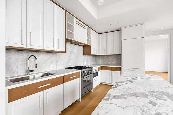 1 Clinton Street, Unit 17B Brooklyn, NY 11201 - Photo 2 of 4 a kitchen with stainless steel appliances granite countertop a sink and cabinets