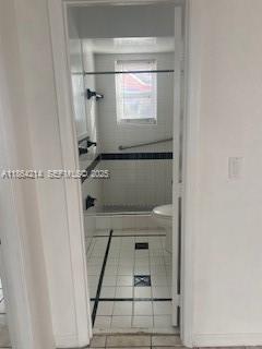 1537 Southwest 1st Street, Unit 2 Miami, FL 33135 - Photo 9 of 10 a bathroom with a shower and a sink