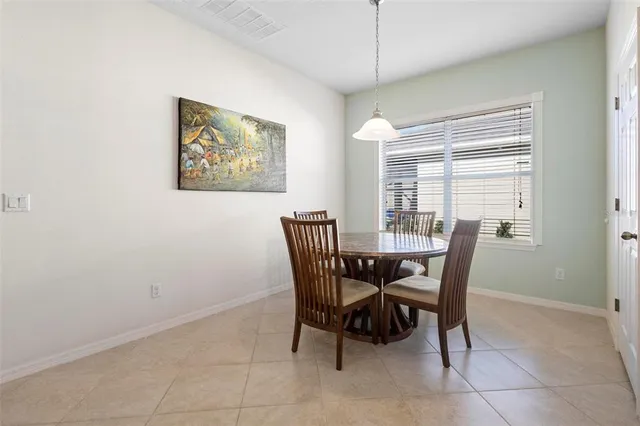 a view of a dining room with furniture and a chandelier