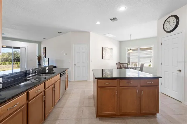 a kitchen with stainless steel appliances granite countertop a sink and a stove