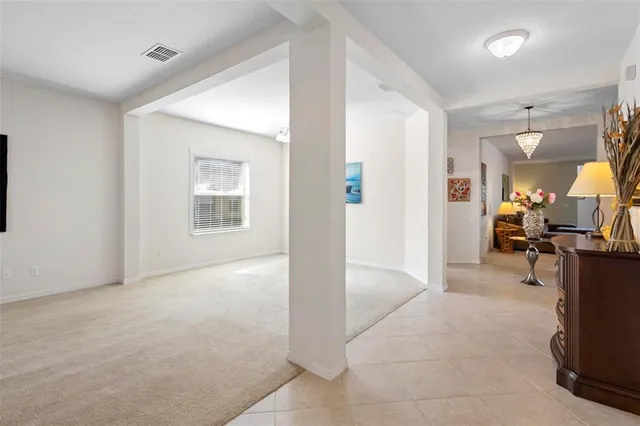 a view of a livingroom with workspace and a window