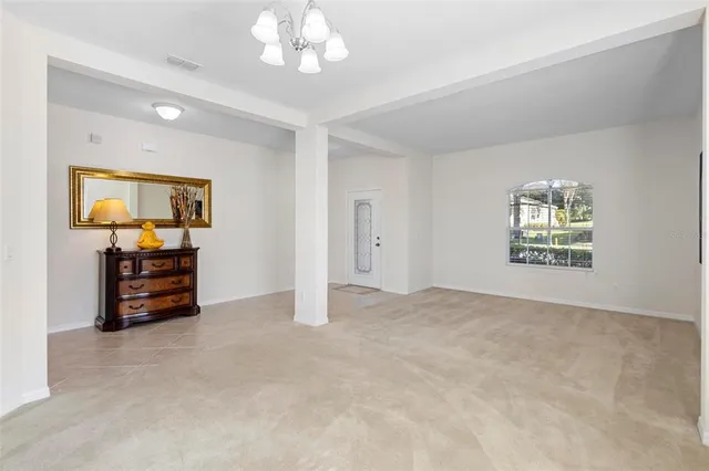 an empty room with furniture and natural light