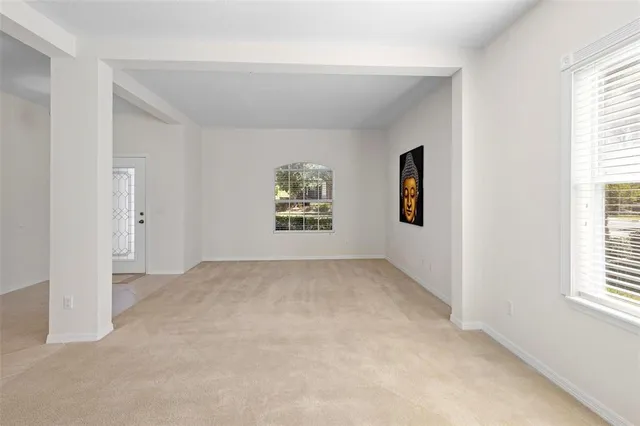 an empty room with windows and closet