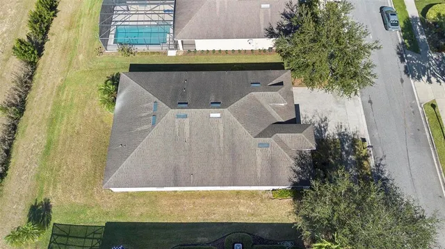 a front view of a house with a yard and potted plants