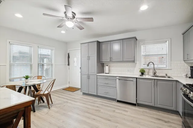 a kitchen with a sink cabinets and window